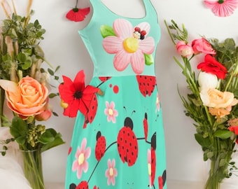 May include: A turquoise sleeveless dress with a pink flower and ladybug print. The dress has a fitted bodice and a flared skirt.