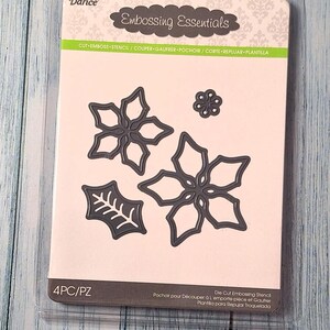 May include: A Darice Embossing Essentials die cut stencil set. The set includes four dark gray floral and leaf designs. The package has the text "Embossing Essentials" and "4PC/PZ". The package is in a clear plastic case.