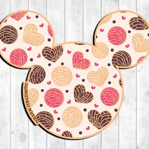 May include: A white background with a Mickey Mouse silhouette filled with a pattern of pink, brown, and beige heart-shaped pastries. The text "Corazoncito" is written on the left ear.
