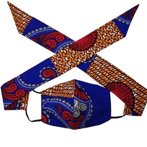 May include: A blue and orange patterned face mask with matching fabric headband. The mask has a red and white paisley design.