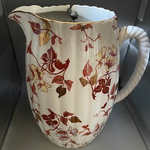 Antique lidded water jug white colour and gilt flowers decorations, marked Ridgways Etwall England reg number