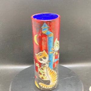 Red vase with cats