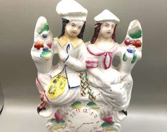 Antique  Staffordshire hand painted porcelain  figurine of couple with clock face