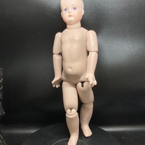 Reproduction of French jointed doll with ceramic body , marked PMC, ceramics