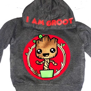 May include: A gray hooded sweatshirt with a red circle featuring a cartoon image of Groot from Guardians of the Galaxy. The text "I AM GROOT" is printed in red on the hood.