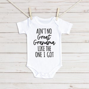 May include: White baby onesie with black text that reads "Ain't no Great Grandma like the one I got".