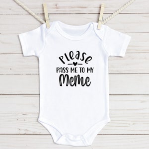 May include: White baby onesie with black text that reads "Please pass me to my Meme" with a small heart between "Please" and "pass".