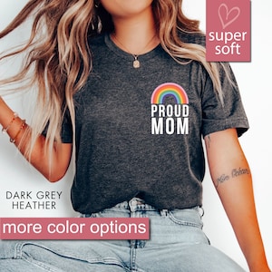 May include: Dark grey heather t-shirt with a rainbow and the text "Proud Mom".