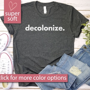 May include: A dark gray t-shirt with the text "decolonize." printed in white. The shirt is made of a soft, comfortable material.