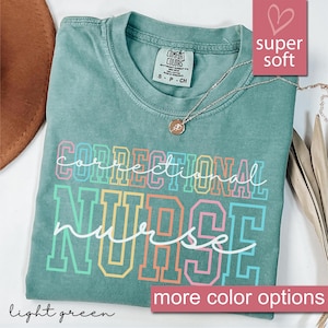 May include: Light green t-shirt with the text "correctional nurse" in rainbow colors. The shirt is super soft and comfortable.