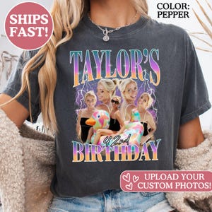 May include: A pepper-colored t-shirt featuring a graphic print with the text "TAYLOR'S 4 2nd BIRTHDAY" in a gradient font. The design includes multiple photos of a person on a colorful inflatable duck, set against a purple lightning background.