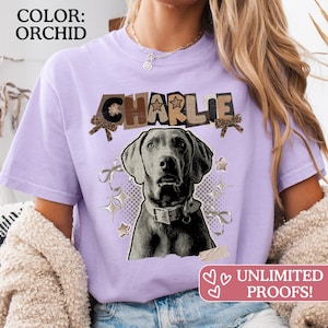 May include: Orchid-colored t-shirt featuring a grayscale image of a dog with the name "CHARLIE" in a collage-style design. The shirt includes decorative stars and ribbons. The text "UNLIMITED PROOFS!" is in a pink banner.