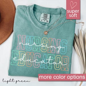 Puede incluir: Camiseta verde claro con el texto "nursing educator" en colores arco&iacute;ris. La camiseta est&aacute; hecha de una tela suave y c&oacute;moda.