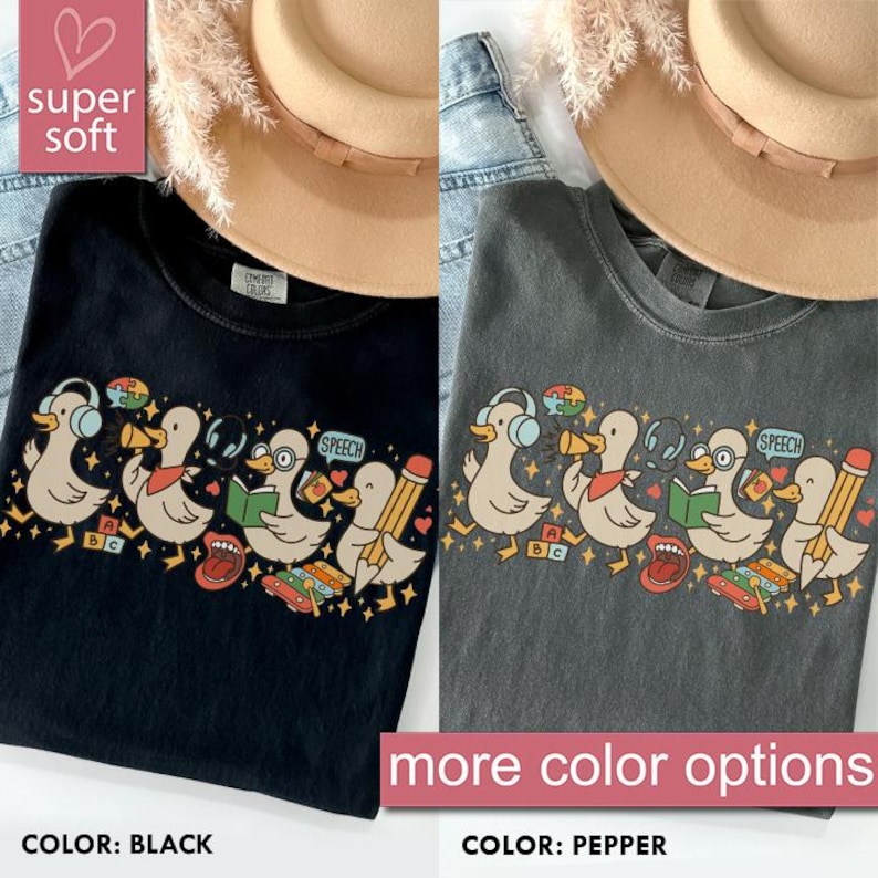 May include: Black and pepper-colored t-shirts with a graphic of cartoon ducks wearing headphones, holding books, and pencils. The shirts have the text "SPEECH" and "ABC". The image also includes the text "super soft" and "more color options".