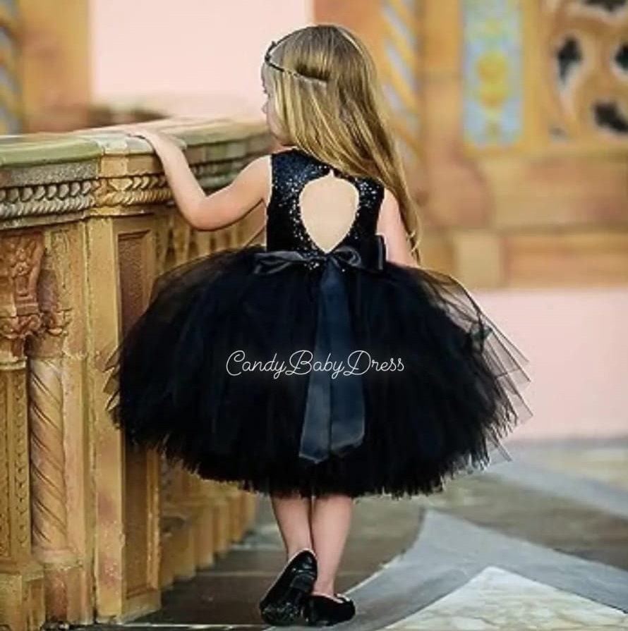 Premium Photo | A baby girl in a black dress with a bow on her head