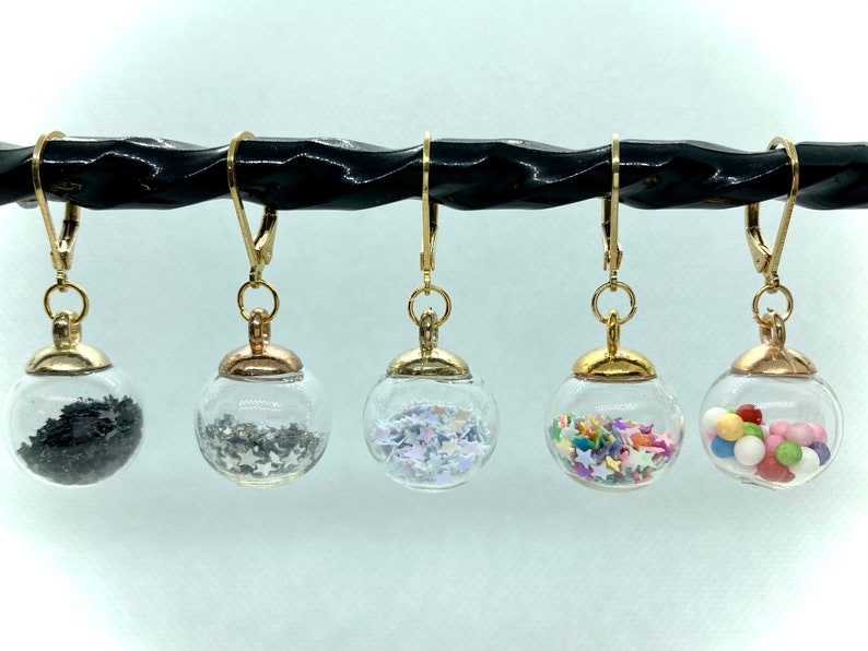 Glass globes stitch markers with shiny stars or gumballs