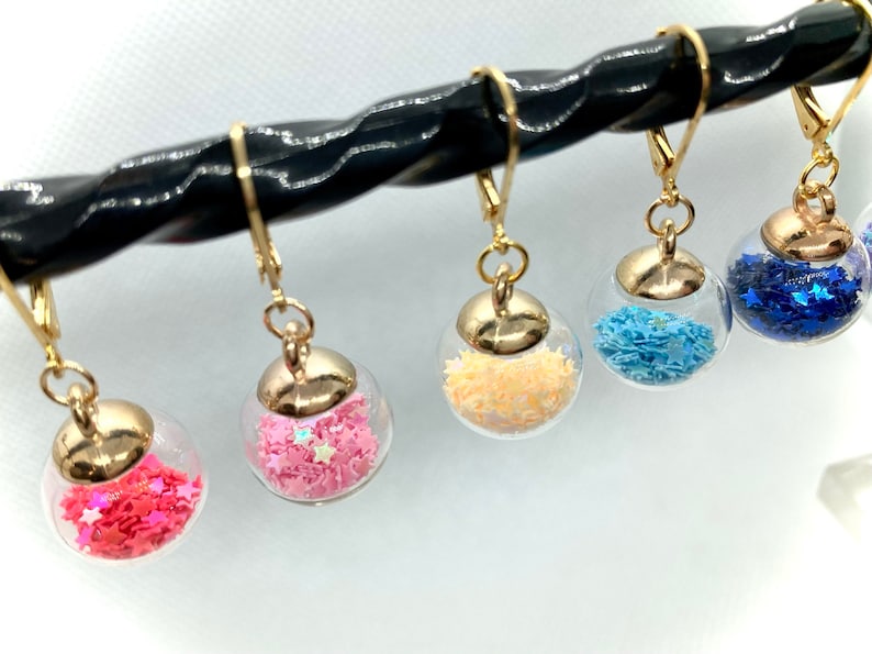 Glass globes stitch markers with shiny stars or gumballs