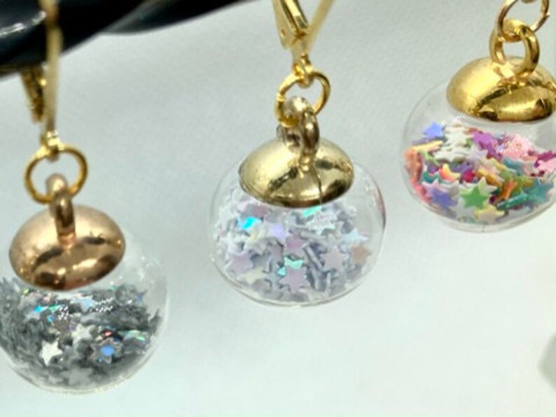 Glass globes stitch markers with shiny stars or gumballs