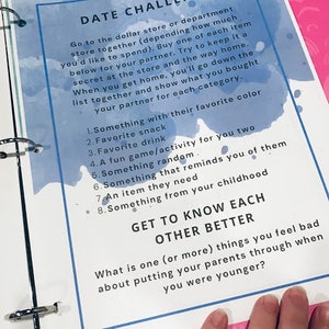 May include: A pink and blue date night challenge card with the number 8 in a white circle. The card has instructions for a date night challenge that involves going to the dollar store and buying items for each other. The card also includes a list of 8 things to buy for your partner.