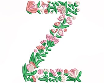 Può includere: Una lettera Z floreale realizzata con fiori rosa e bianchi con foglie verdi. La lettera è ricamata e sarebbe perfetta per un progetto di artigianato.
