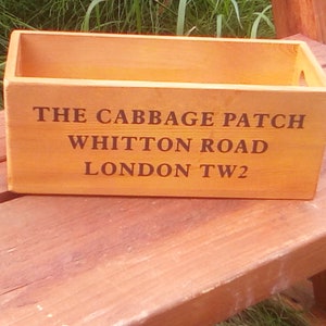 May include: A wooden box with the text "THE CABBAGE PATCH WHITTON ROAD LONDON TW2" printed on the front.