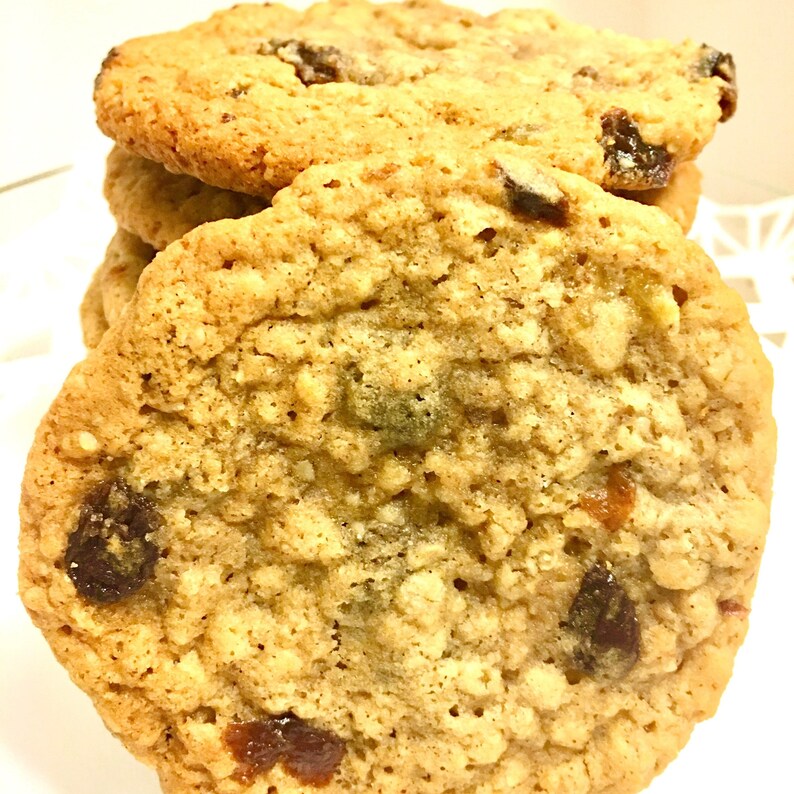 May include: Close-up of a stack of oatmeal raisin cookies. The cookies are golden brown and have a chewy texture. The raisins are evenly distributed throughout the cookies.