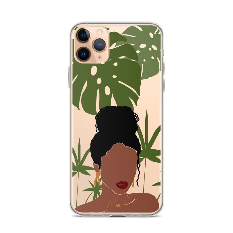 May include: A clear phone case with a design of a woman with dark brown skin and black hair, wearing gold earrings. The background is a light beige with green tropical leaves.