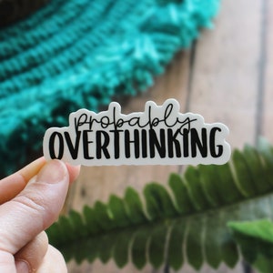 May include: White sticker with black text that reads "probably overthinking".