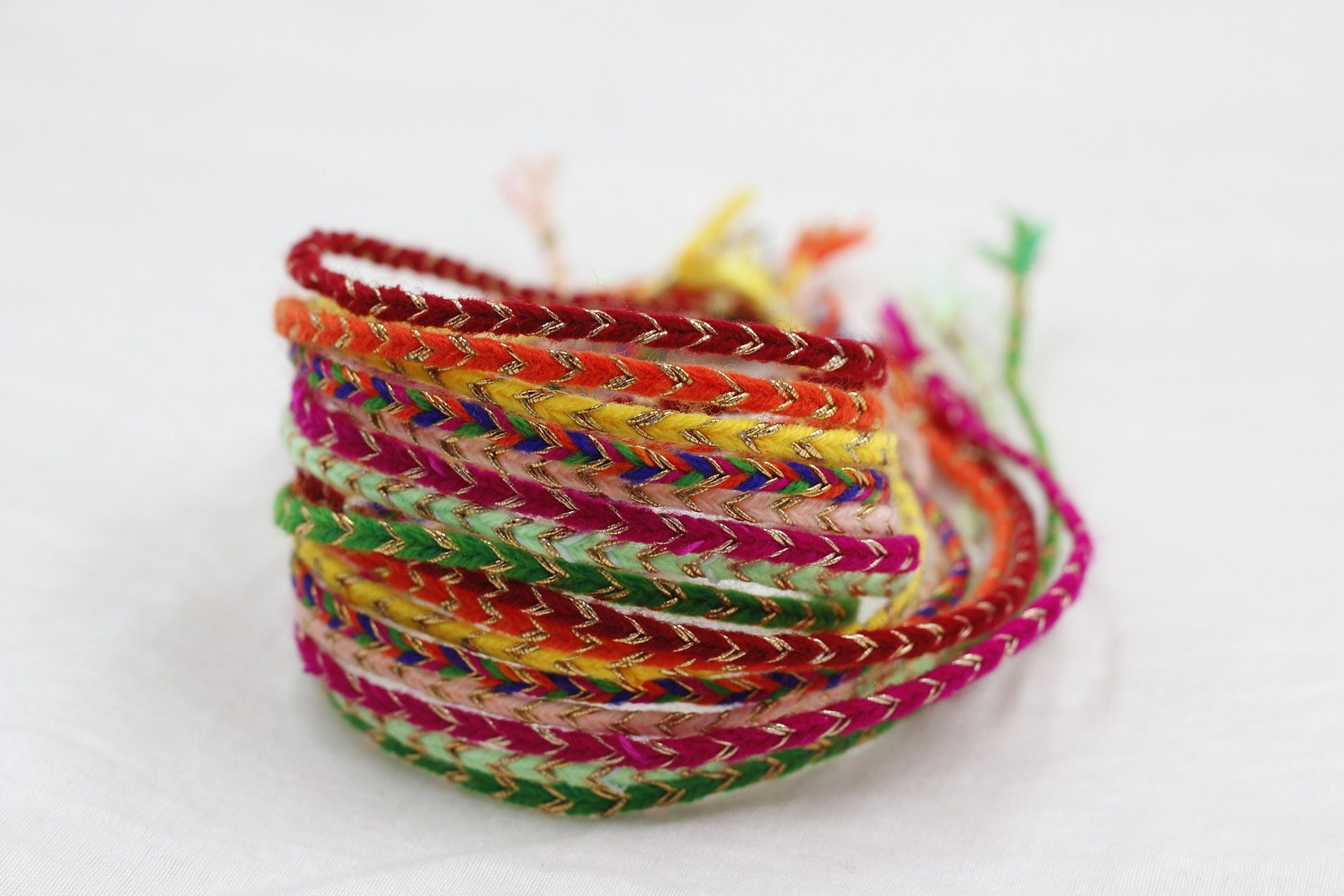 A pack of 8 Rakhi Doris with a COMPLIMENTARY CARD and Roli Chawal Pack