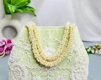 May include: A light green velvet handbag featuring intricate white beadwork and sequin floral embroidery. The bag includes two handles constructed from strands of cream-colored faux pearls. The text GW4230-3 is visible in the upper right corner.