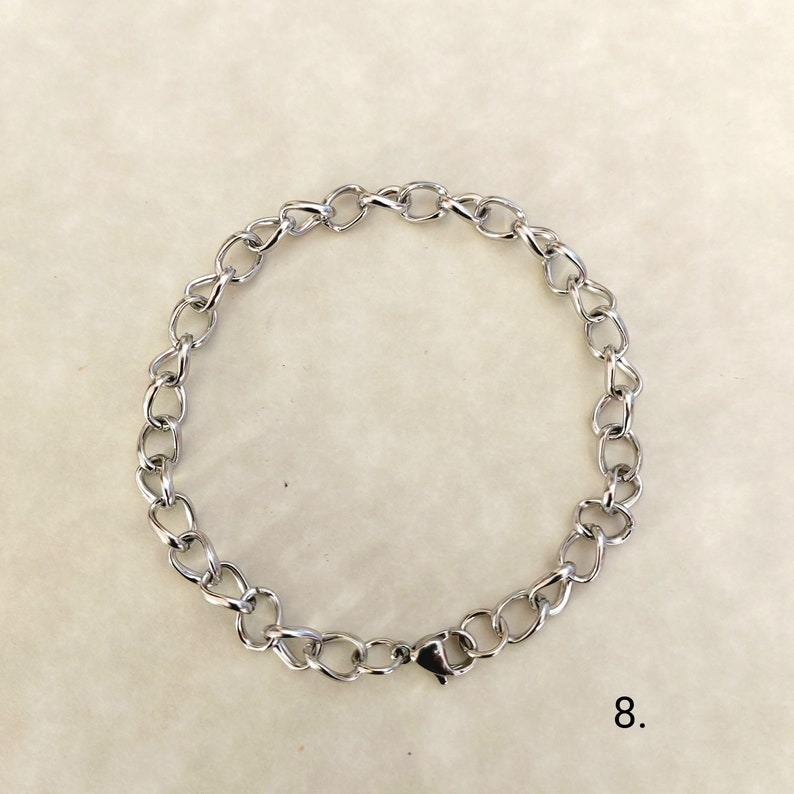 May include: A silver chain bracelet with a lobster clasp closure.