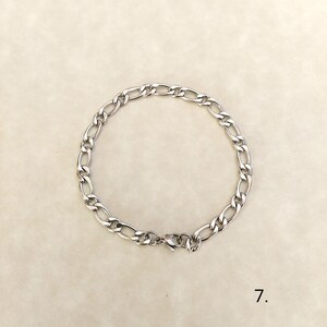 May include: A silver chain bracelet with a lobster clasp closure.
