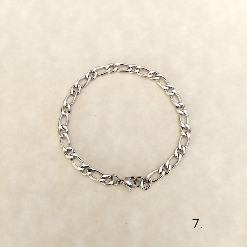 May include: A silver chain bracelet with a lobster clasp closure.
