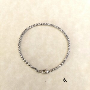 May include: A silver chain bracelet with a lobster clasp closure.