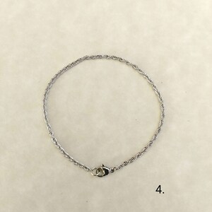 May include: A silver rope chain bracelet with a lobster clasp.
