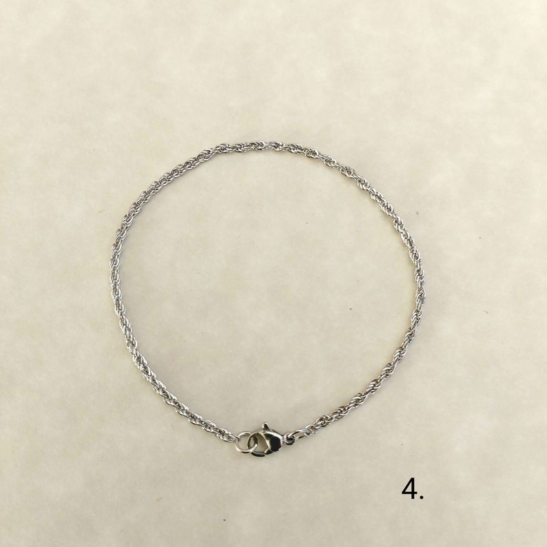 May include: A silver rope chain bracelet with a lobster clasp.