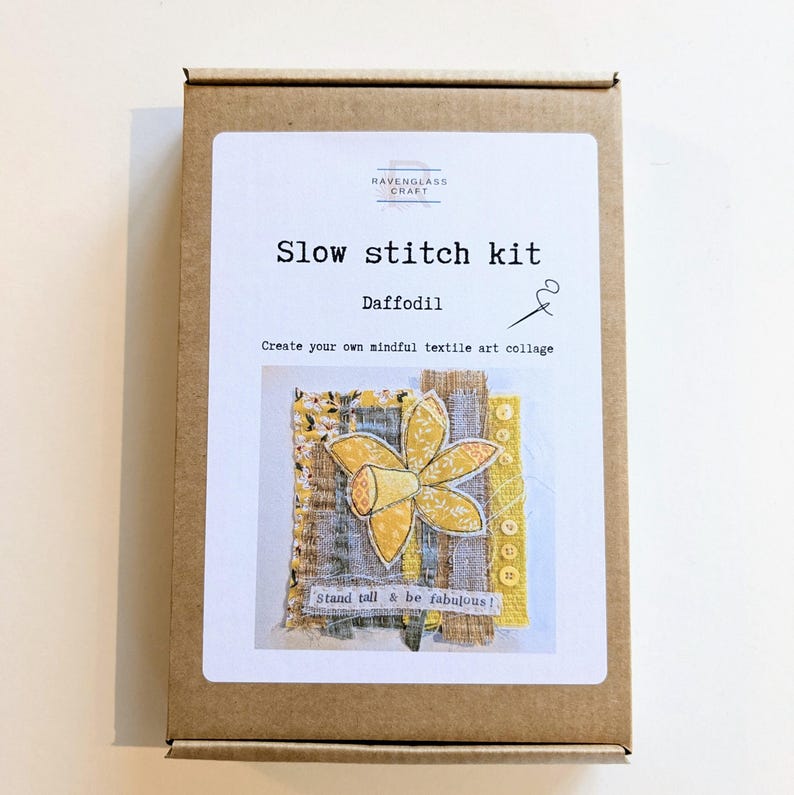 May include: A brown cardboard box containing a slow stitch kit. The kit features a daffodil design with yellow and white accents. The text on the box reads "Slow stitch kit" and "Daffodil". The kit includes the text "Stand tall & be fabulous!"