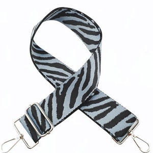 May include: A black and light blue zebra print adjustable strap with silver hardware.
