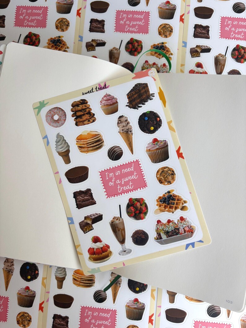 May include: A sticker sheet with illustrations of sweet treats such as cupcakes, ice cream, and waffles. The stickers have a light pink border and the text "I'm in need of a sweet treat". The stickers are displayed on a white background.