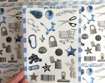 May include: A sheet of stickers featuring diverse designs such as stars, a bunny, scissors, and a shopping trolley. The stickers are in blue, grey, and white, with the text "you're a star".