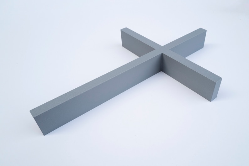 Peut inclure: Une croix en bois grise avec un design simple. La croix est faite d'une seule pi&egrave;ce de bois et a une finition lisse.