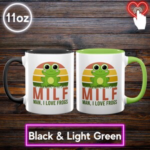 May include: Two 11oz ceramic mugs, one with a black handle and the other with a light green handle. Each mug features a green frog graphic with the text "MILF MAN, I LOVE FROGS" against a sunset background. The bottom text reads "Black & Light Green".