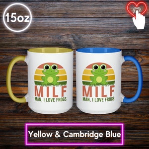May include: Two white ceramic mugs with colorful accents. One has a yellow handle and interior, the other a Cambridge blue handle and interior. Each mug features a green frog graphic with the text "MILF, MAN, I LOVE FROGS" and holds 15 oz.