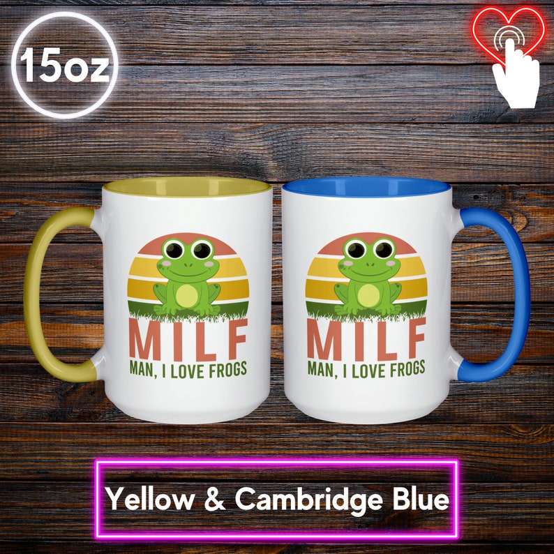 May include: Two white ceramic mugs with colorful accents. One has a yellow handle and interior, the other a Cambridge blue handle and interior. Each mug features a green frog graphic with the text "MILF, MAN, I LOVE FROGS" and holds 15 oz.