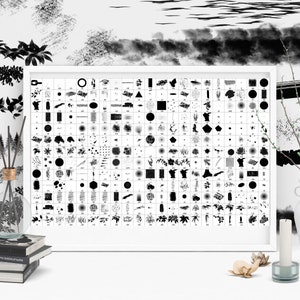May include: A white framed poster with a grid of black and white brushstrokes, shapes, and patterns. The poster is on a white surface with a vase, a candle, and a stack of books.