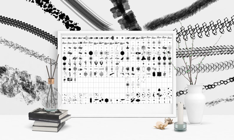 May include: A white framed poster with a grid of black and white brushstrokes and patterns. The poster is on a white surface with a vase of branches, a candle, and a stack of books.