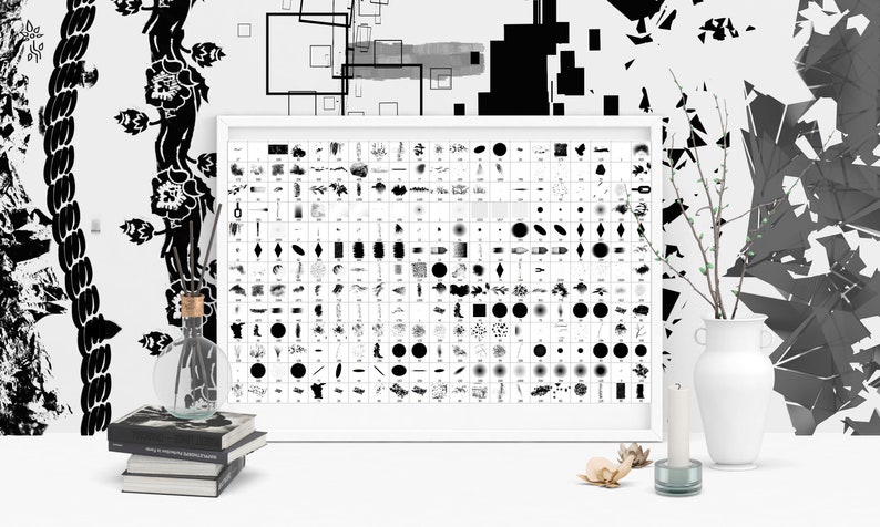 May include: A framed black and white poster with a grid of various brush strokes, shapes, and textures. The poster is on a white surface with a vase, a candle, and a stack of books.