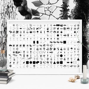 May include: A black and white poster with a grid of various brush strokes and shapes. The poster is framed in a white frame and is hanging on a white wall. There are a few decorative items on the table in front of the poster, including a vase with a branch, a candle, and a glass bottle.