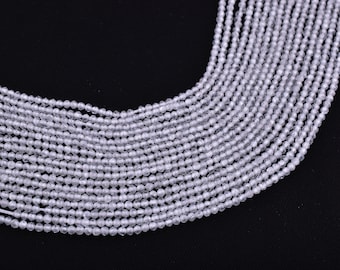 May include: A strand of white crystal beads, each bead is round and has a textured surface.