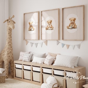 May include: Three framed prints featuring watercolor teddy bears on a striped background. The prints are in a nursery setting, with a woven giraffe, storage bench, and decorative pillows. The color palette is soft and neutral.